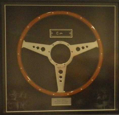 Lot 81 - A wood rimmed steering wheel signed by Stirling Moss & Tony Brooks